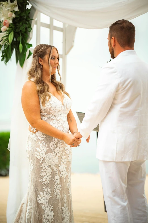 a woman and a man in white are getting married