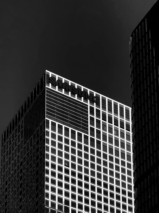 some very tall buildings against a cloudy sky