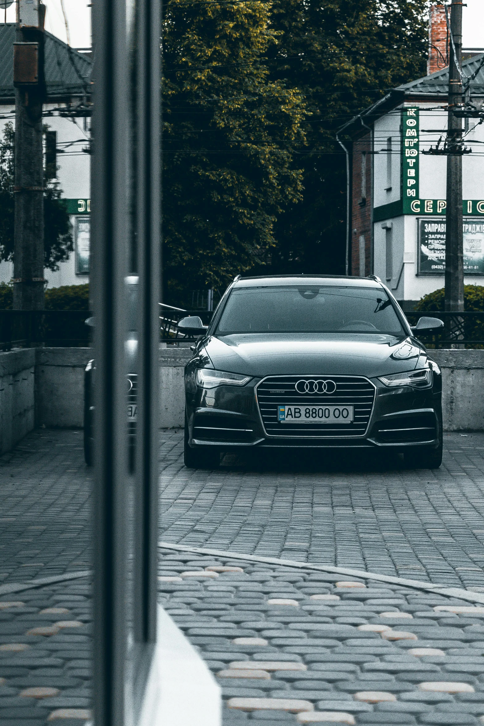 a car is parked on a brick driveway