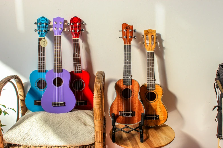 the four guitars are made of wood and have intricately decorated strings