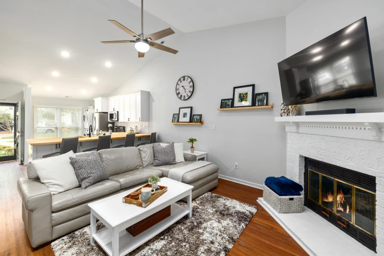 a living room filled with furniture and a flat screen tv