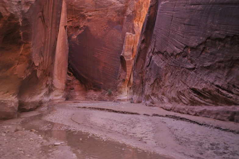 a narrow section of a road cuts through a large canyon