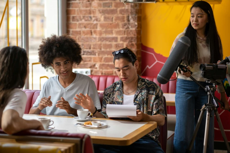 three women sitting around a table eating cake