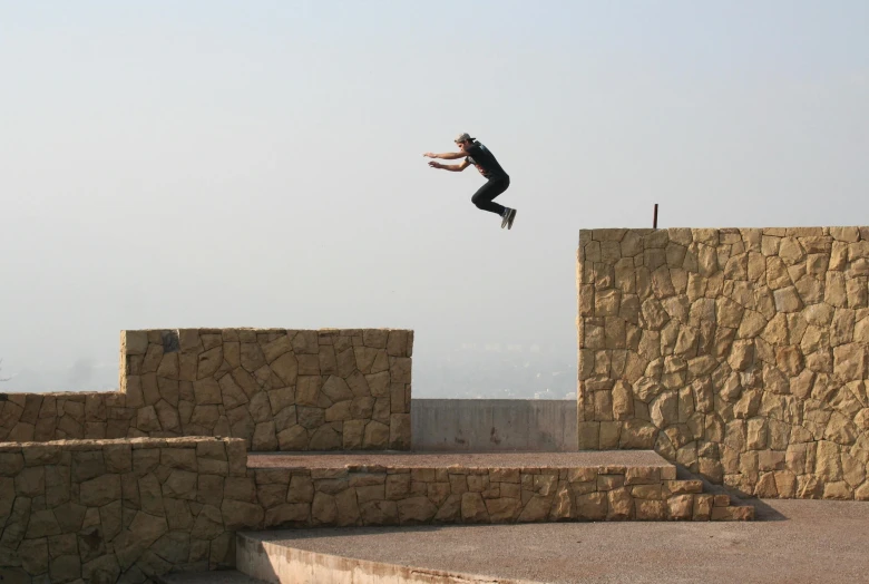 a man jumping over steps on top of some rocks