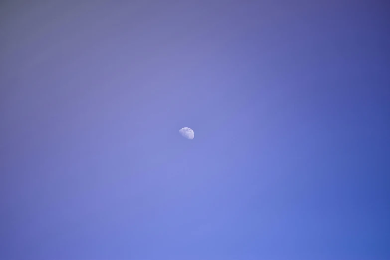 the moon is in the blue sky with no clouds