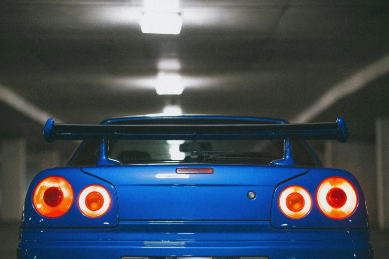 a blue sports car with red lights at the top