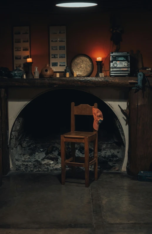 a room with wood chairs and an old fashioned fireplace