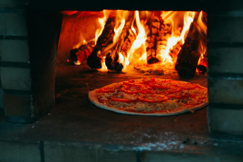 a pizza sitting in front of an oven