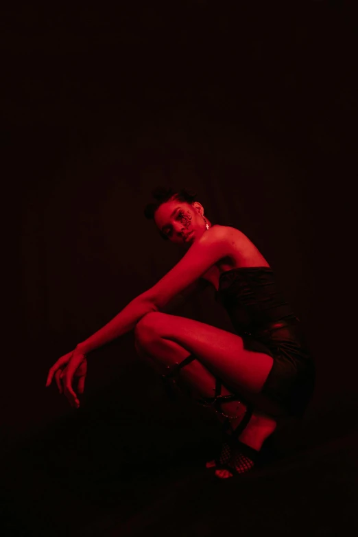 a woman in a black dress with red lights