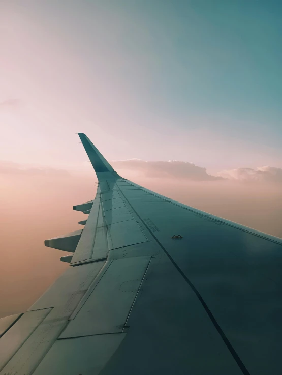 a view from an airplane wing as it is going down the flight