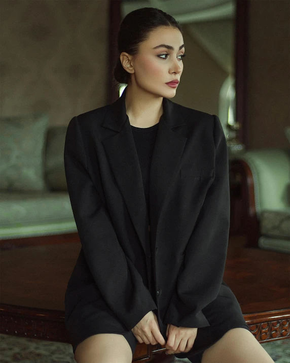 a woman sitting in a chair looking down