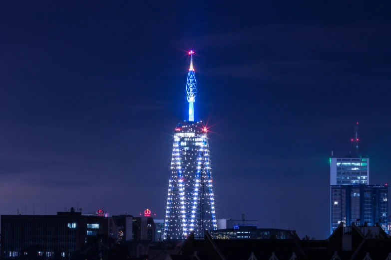 a tall building lit up with bright lights at night