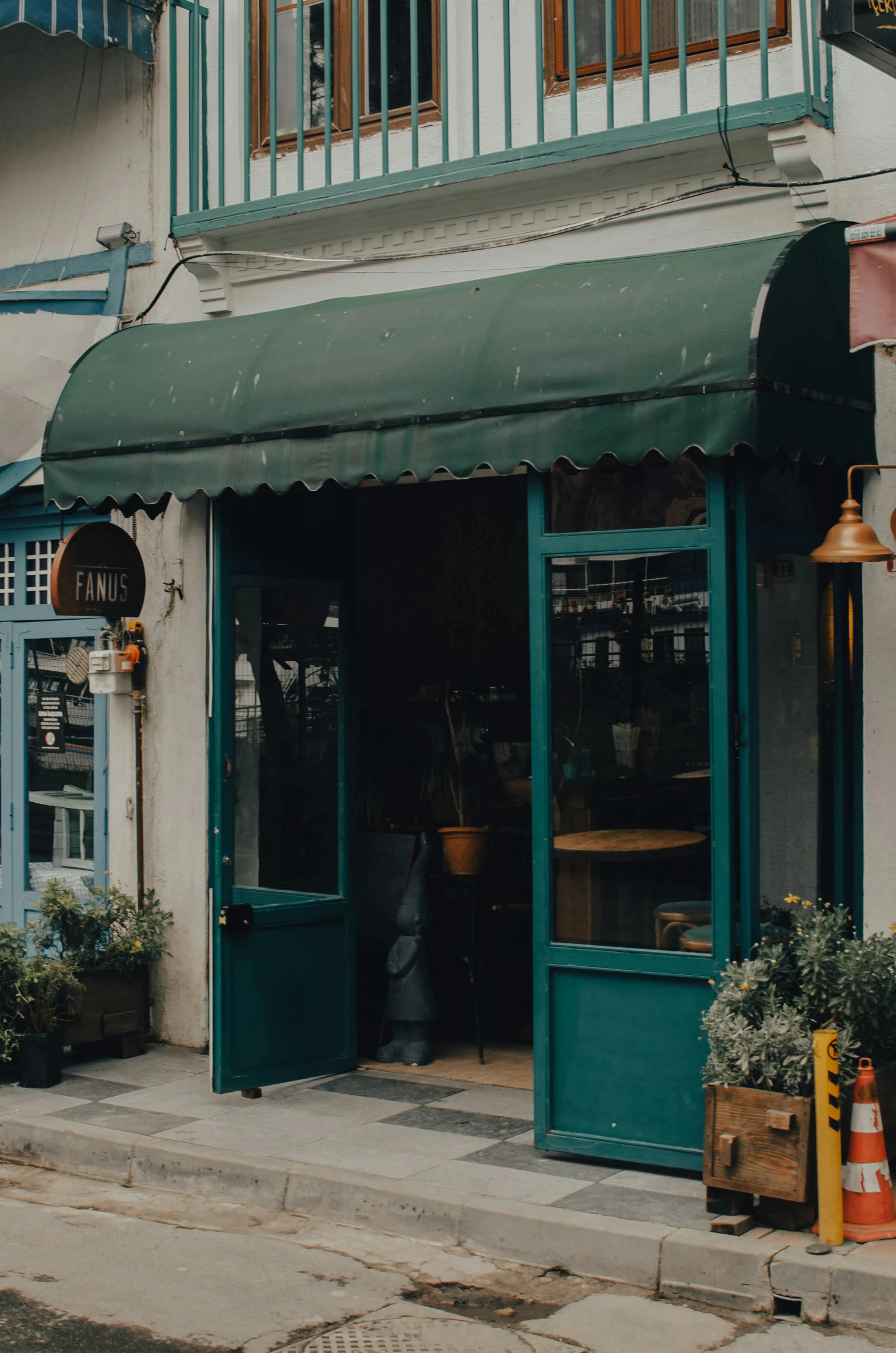 a view of the outside of a restaurant where people are seated