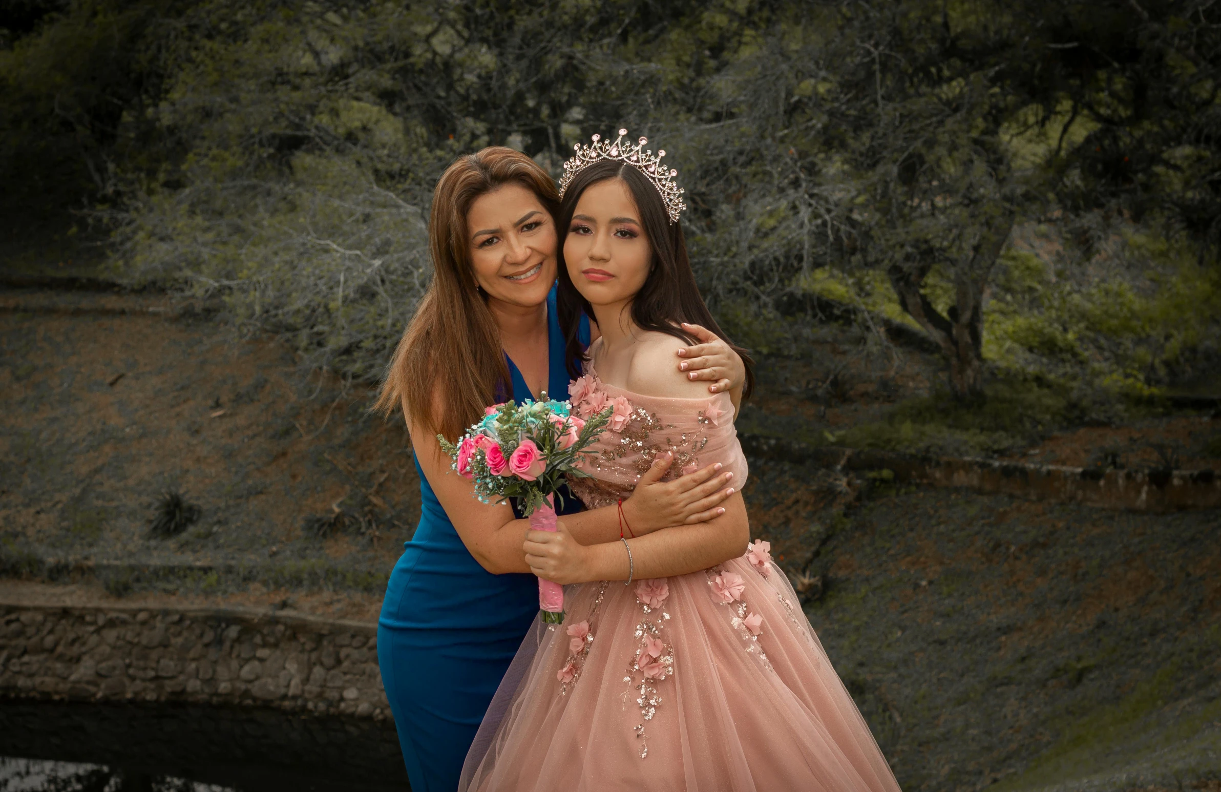 a woman is hugging her daughter in a dress