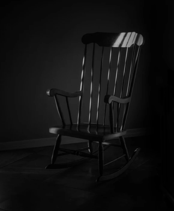 a rocking chair is placed against a wall