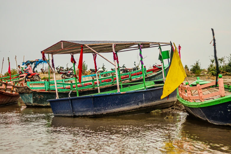 several small boats with umbrellas sit in the water