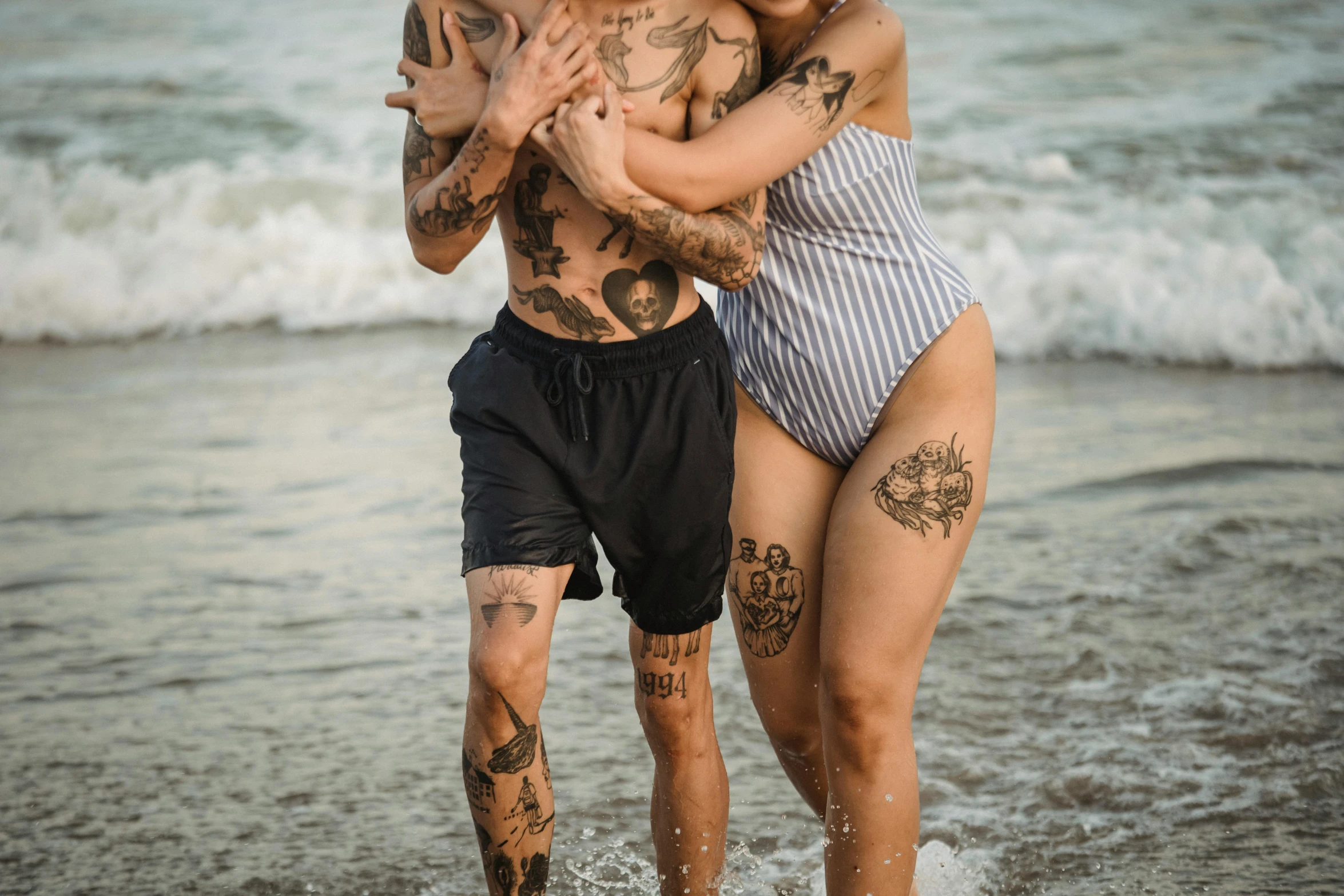 a woman holding her mans head and she is in the water