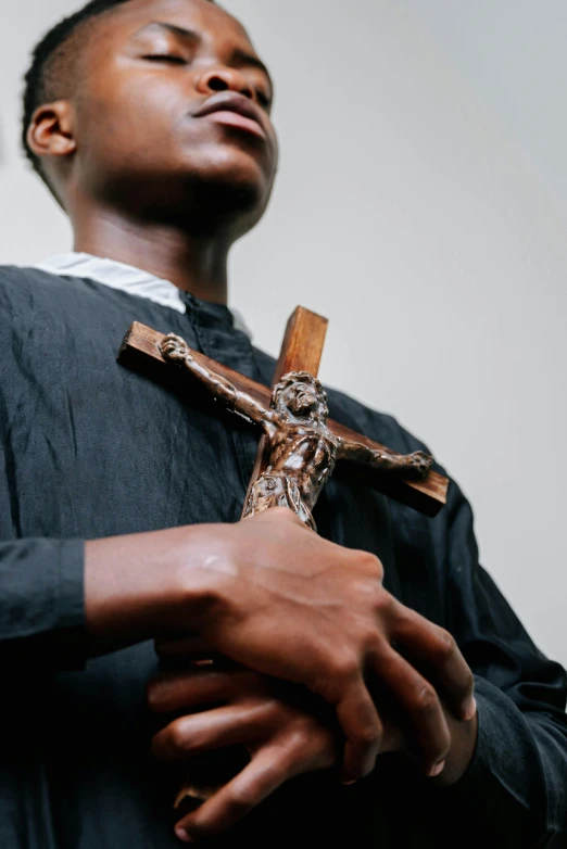 a person is laying their hands on a cross