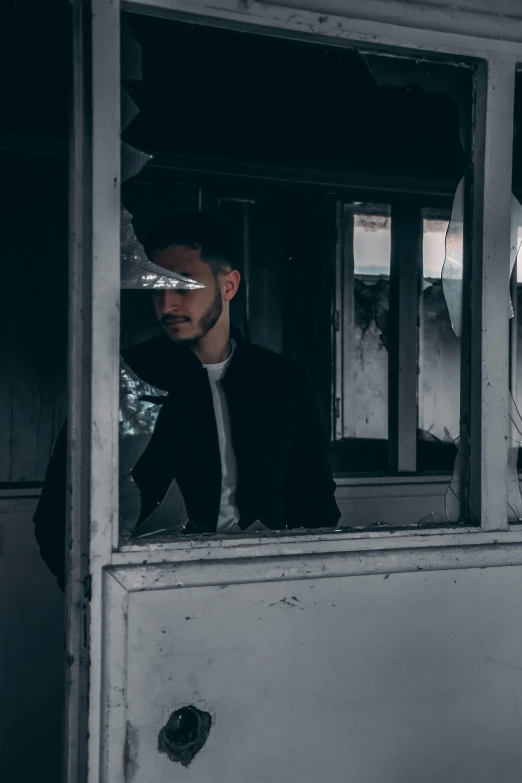 a man standing in the window of a train