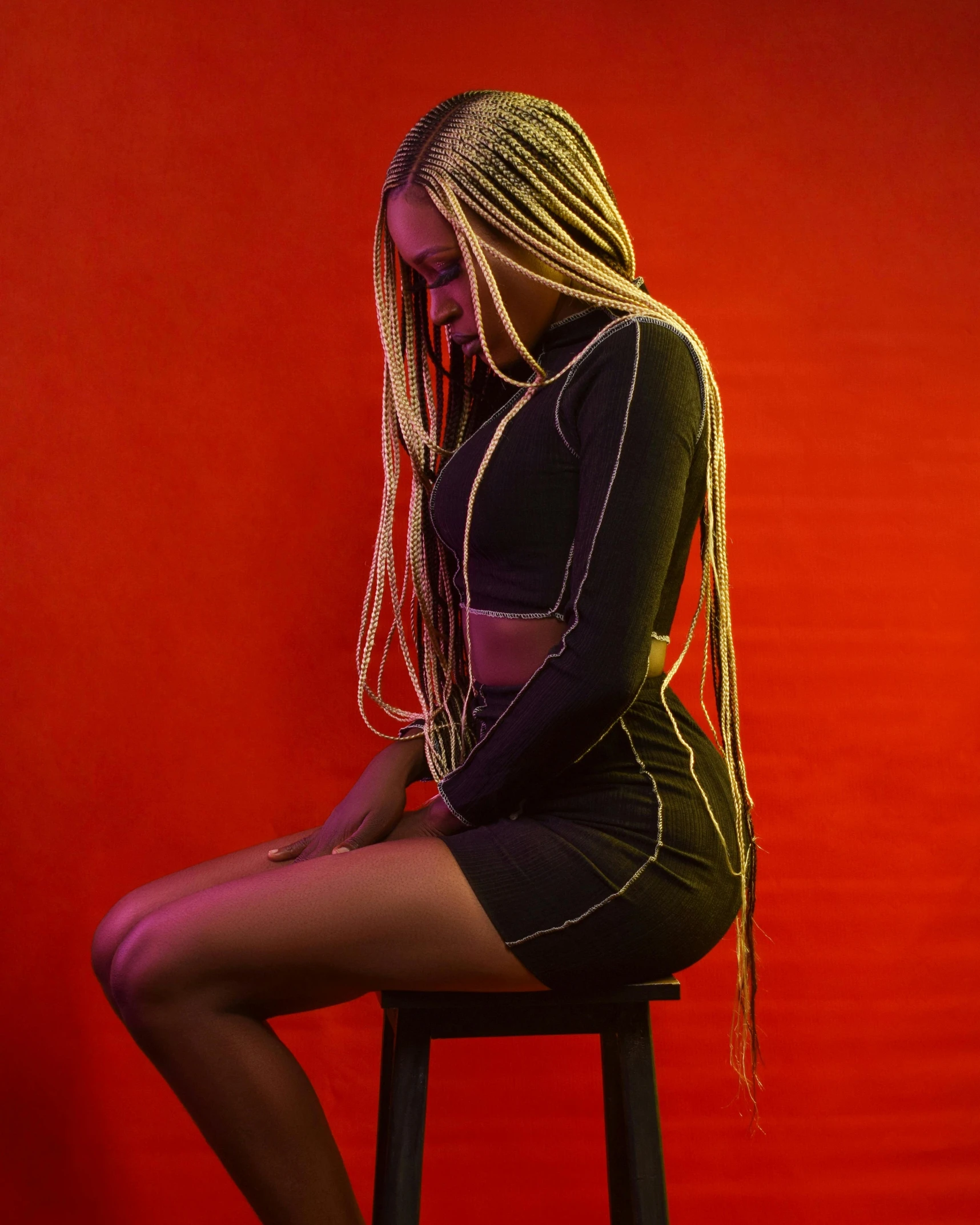 a woman sitting on top of a stool