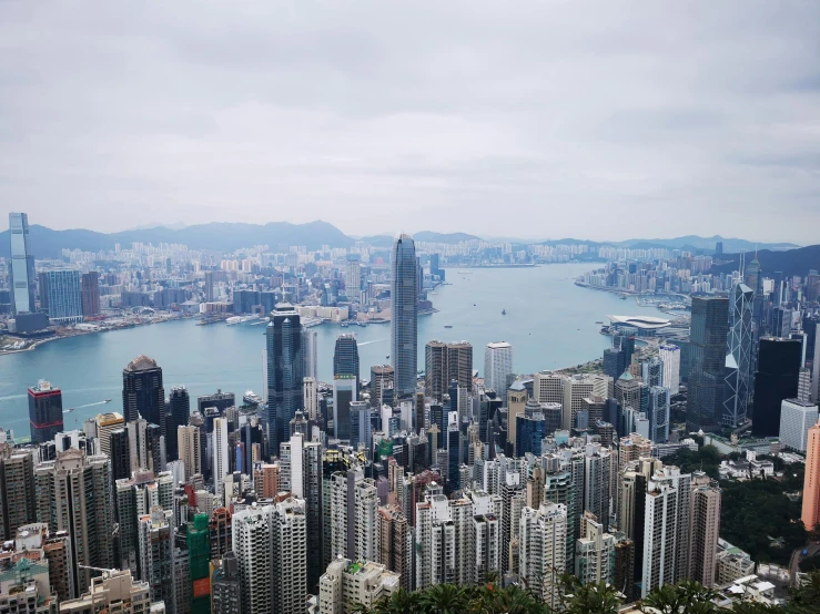 a view of an urban setting with water, hills, and buildings