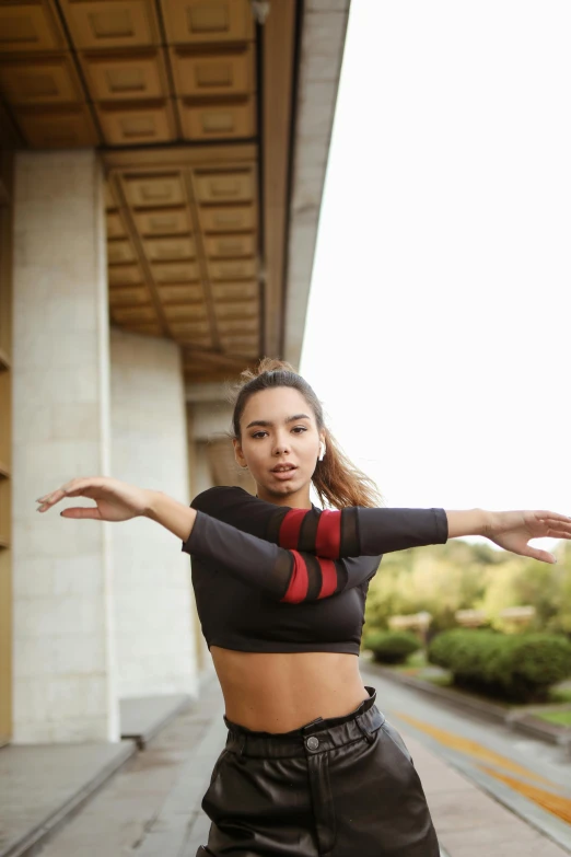 a woman with her arms out doing a trick