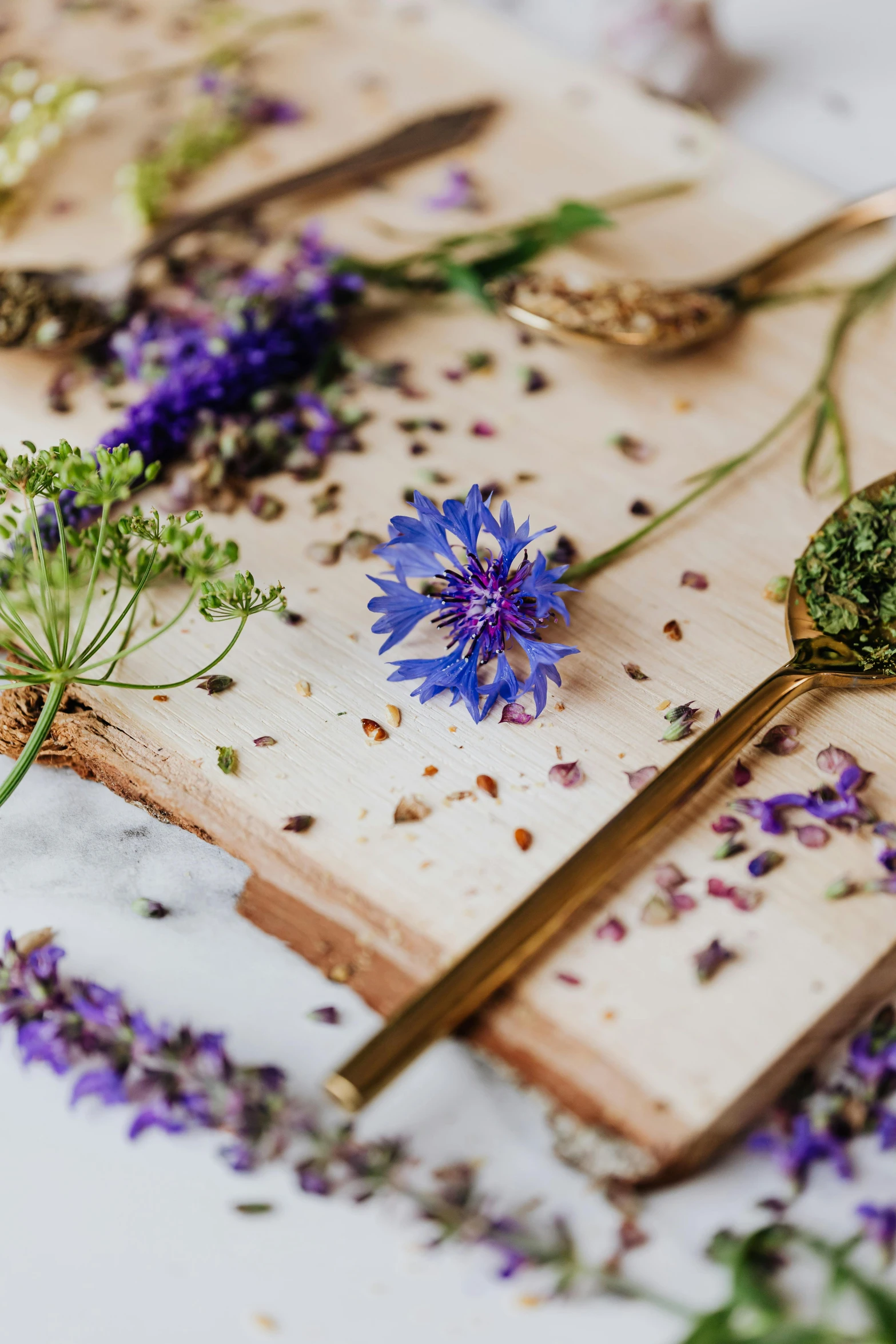 dried lavender flowers and spoons on a  board