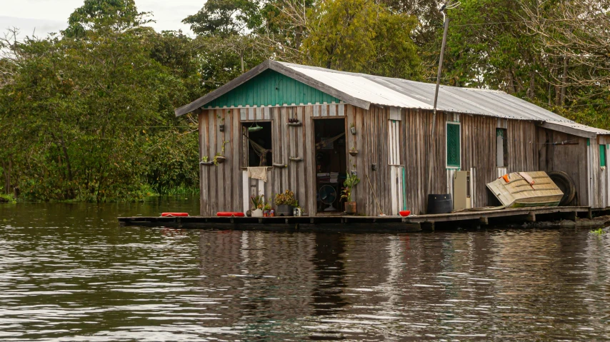 a house boat with lots of things sitting on the water