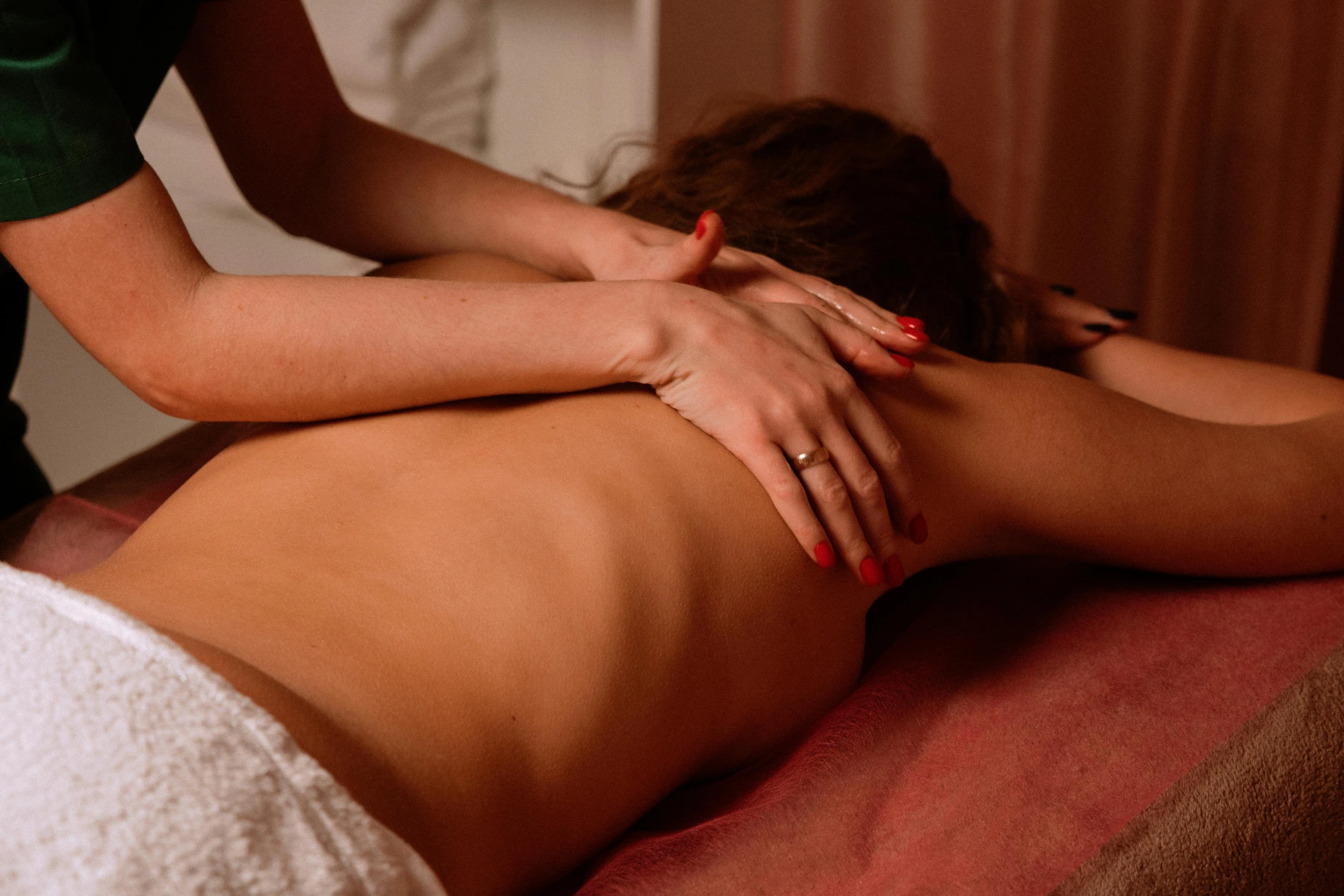 a woman lying on her stomach in a massage room