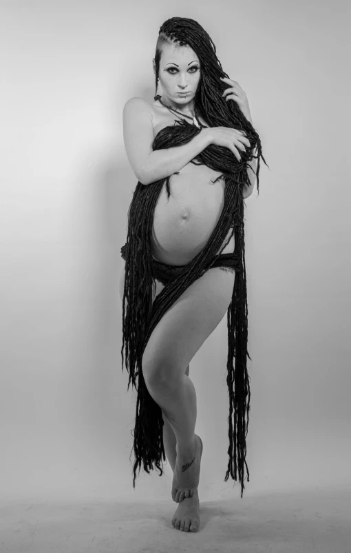 a beautiful pregnant woman in a black bodystocks