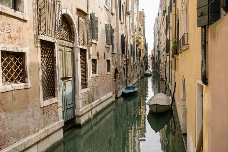 two gondola are lined up on the narrow canals