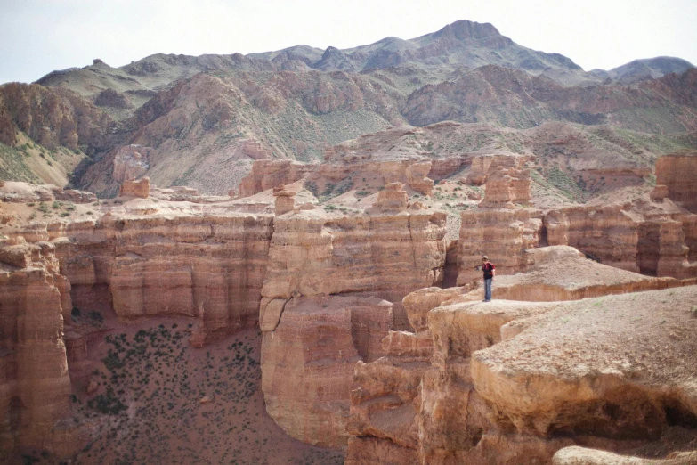 a person standing on the edge of a rocky cliff