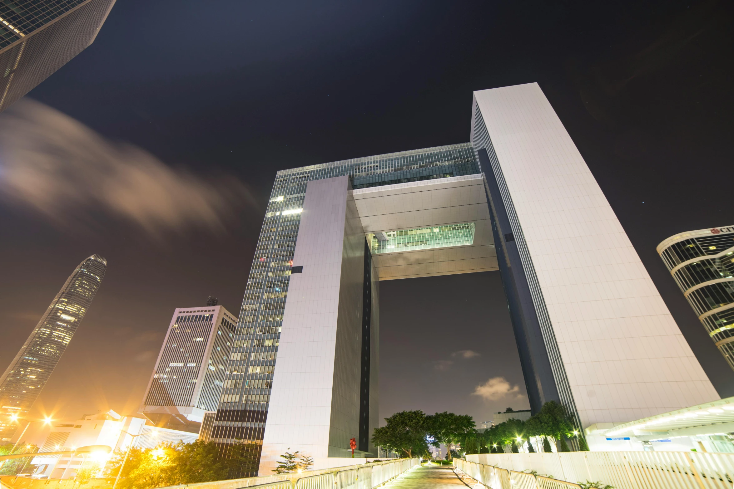 view of skyscrs at night in a city