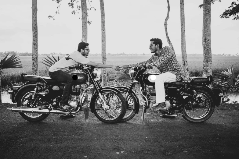 a vintage po of two men sitting on motorcycles