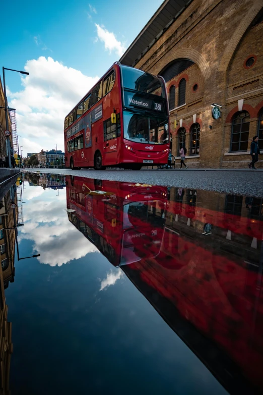 a double decker bus on the road near water