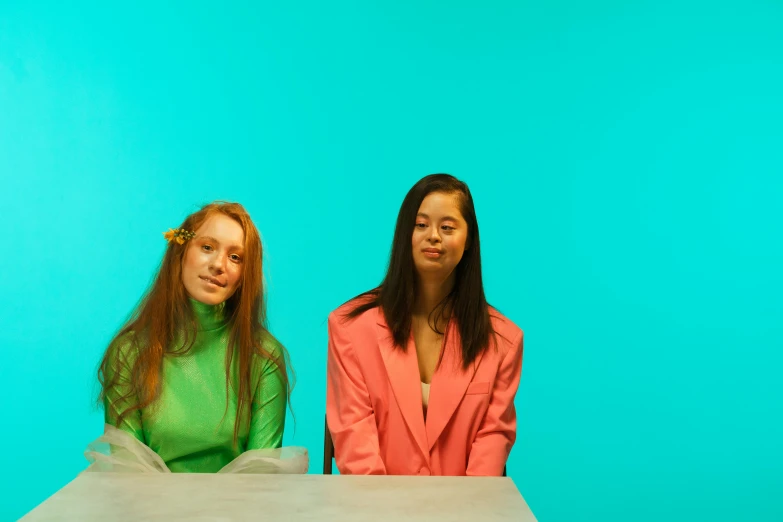 two young ladies sitting next to each other