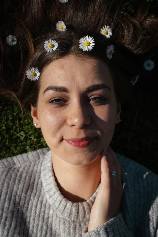 a woman with four daisies in her hair