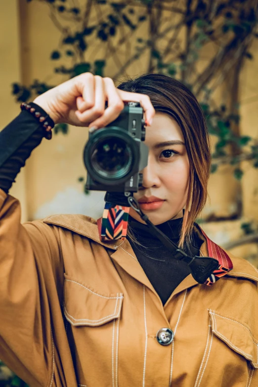 a girl is holding up her camera to take a picture