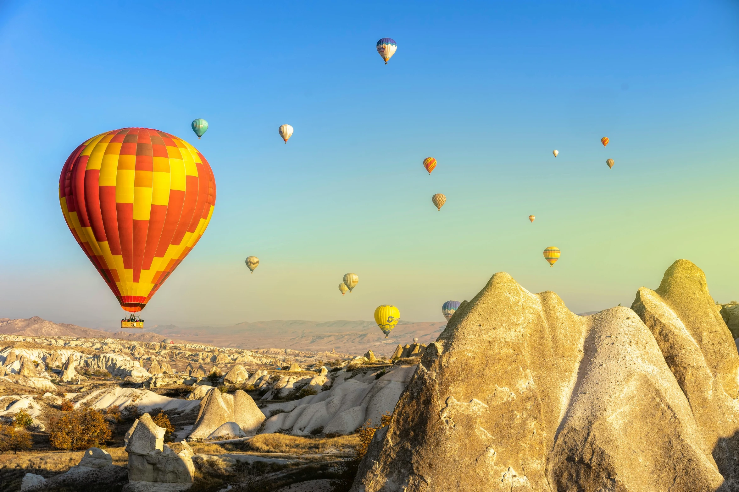 a bunch of  air balloons are being flown