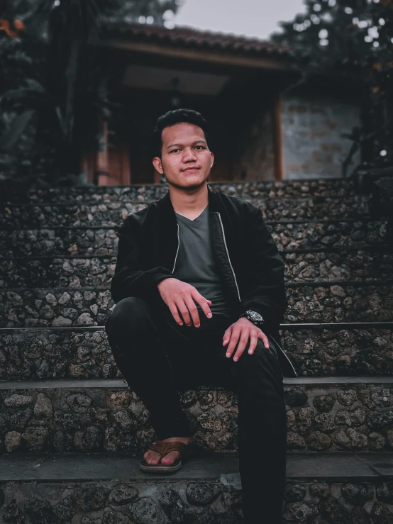 a man sitting down and leaning against a wall