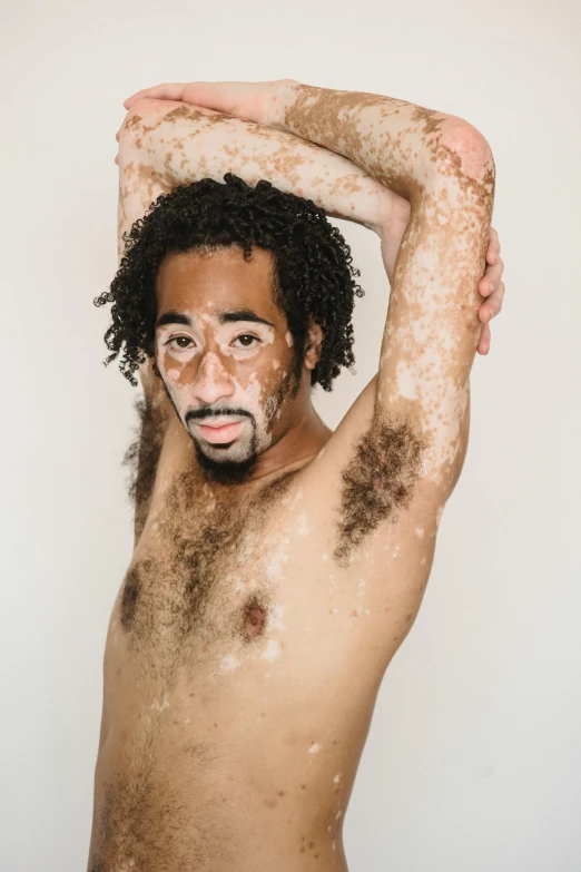 a shirtless man with a lot of dirt on his face