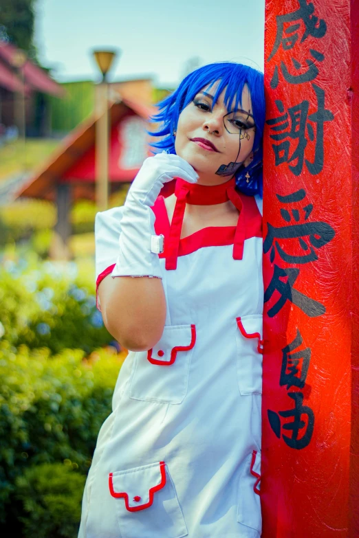 a girl wearing a costume while leaning against a pole