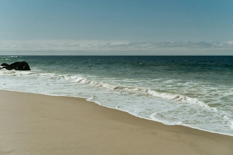 a body of water with waves coming into the shore