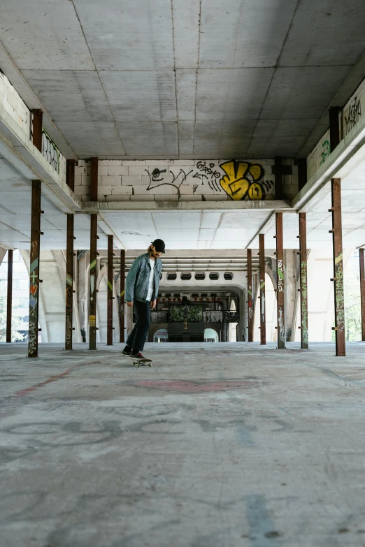 a person skateboards through an abandoned building