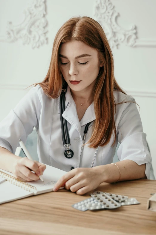 a female doctor is working on an ipad