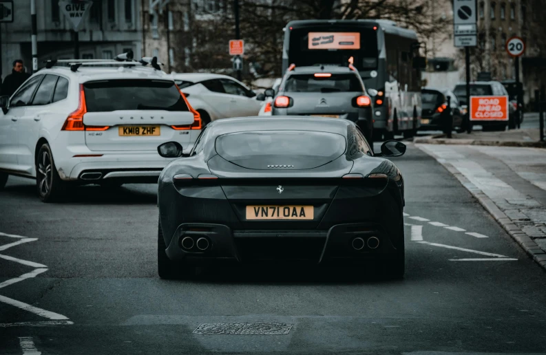 two cars are driving through the city traffic