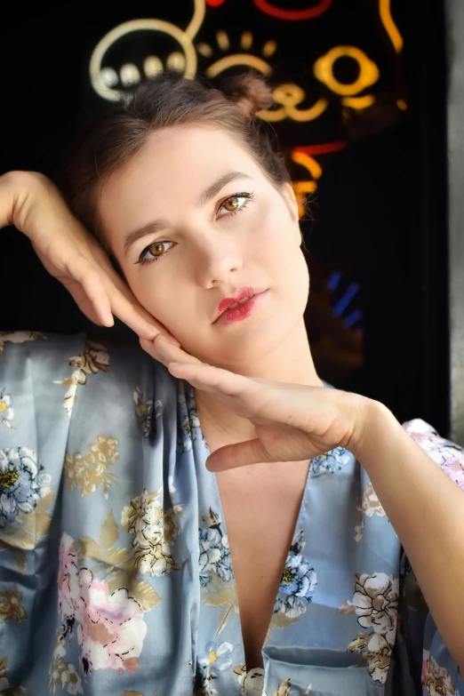 a young woman with her arms folded posing for the camera