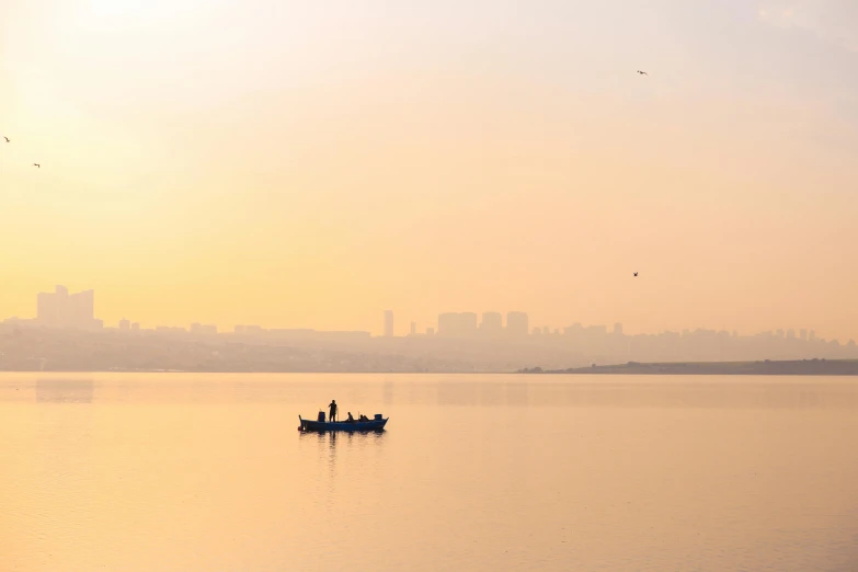 two people in a boat in the middle of the ocean