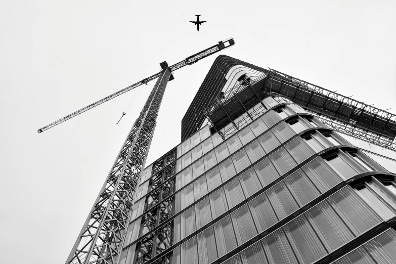 an airplane flies overhead in the cloudy sky