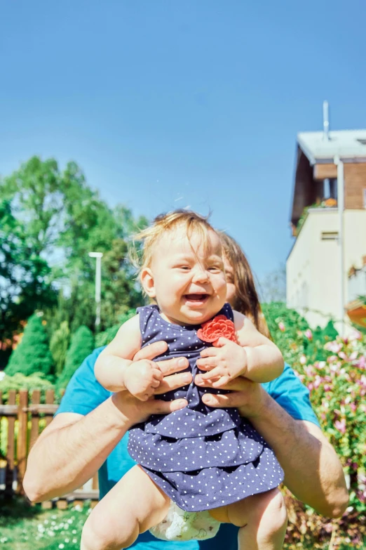 a man holding a little girl on top of his back